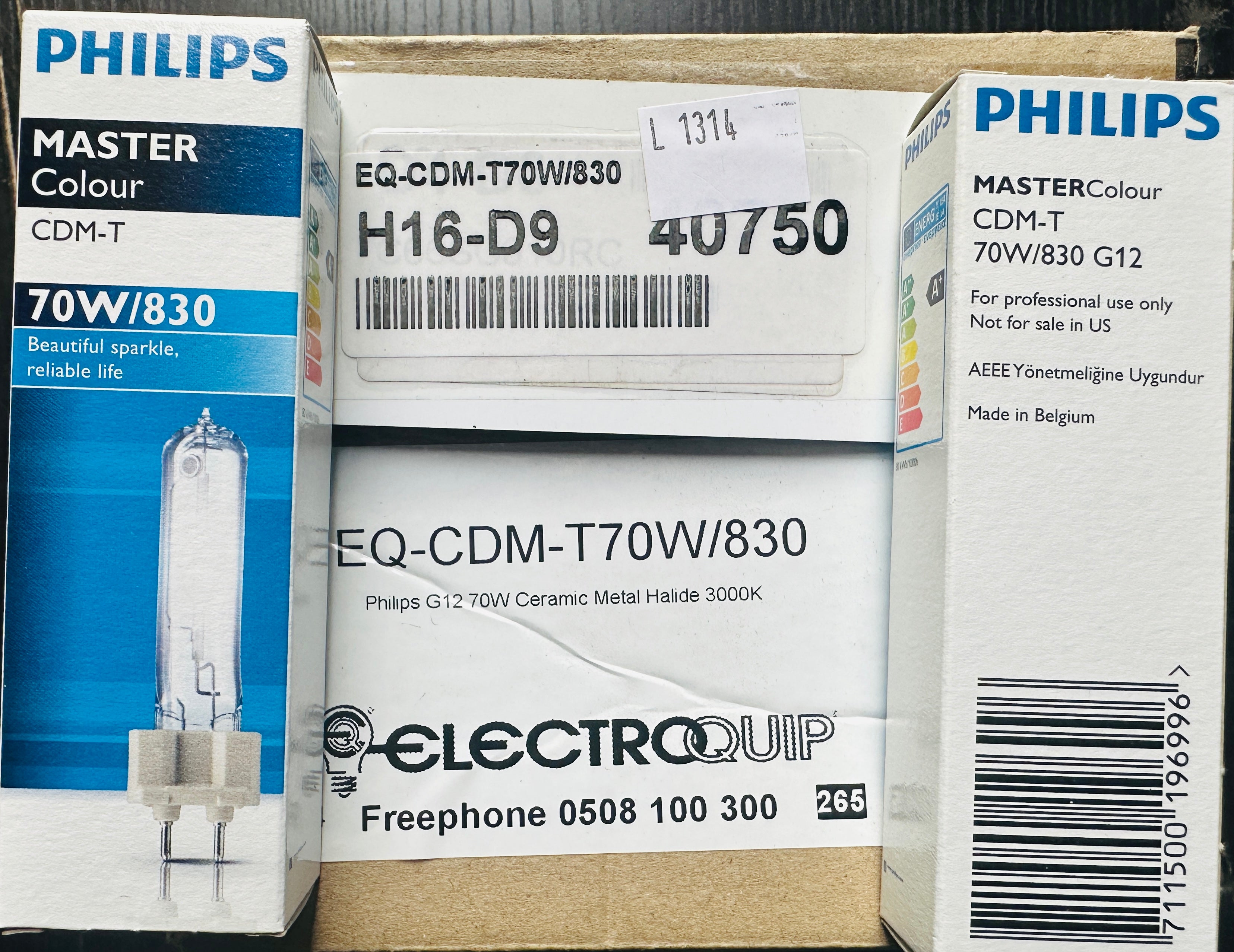 Three Philips Master Colour CDM-T 70W/830 glass replacement light bulbs shown in their original retail packaging, alongside an Electroquip box.